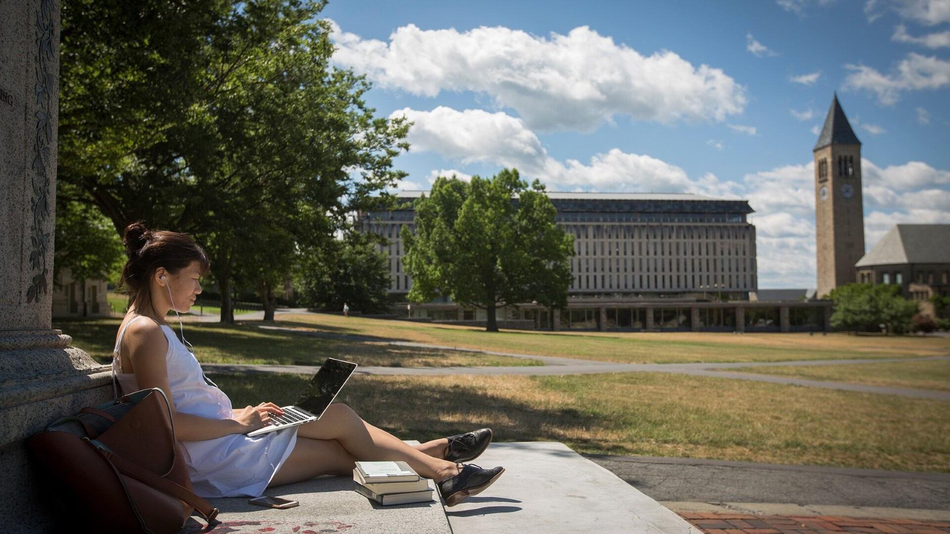 Person sitting with the Chimes Tower in the background