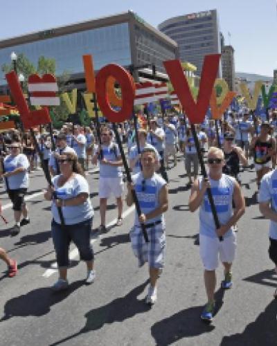 In this June 8, 2014, photo, American Express workers carry giant, cutout letters that spelled, “Love=Love,” the theme of the of the gay pride parade, in Salt Lake City. ( Rick Bowmer / AP Photo )