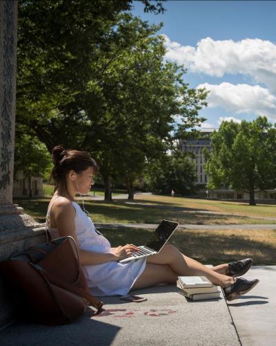 Person sitting with the Chimes Tower in the background