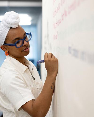 Student writing on white board