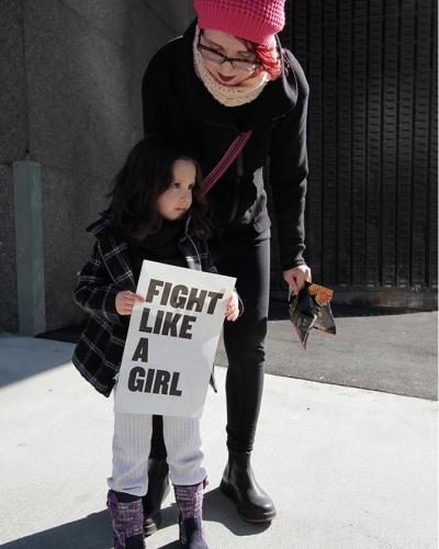 Little girl holding &quot;Fight Like a Girl&quot; sign 
