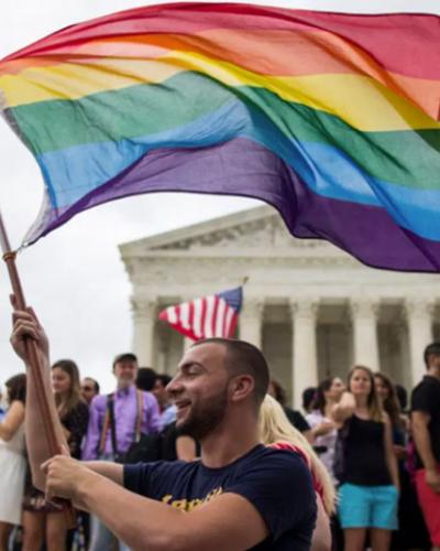 Man waving pride flag