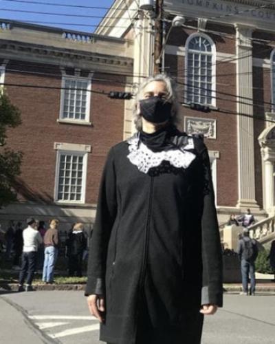 Prof. Liz Karns, industrial and labor relations, dons a dissent collar at the Saturday rally in memory of Justice Ruth Bader Ginsburg &#039;54.